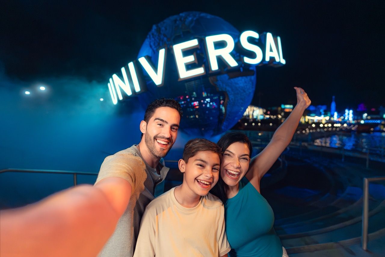 Family celebrating in front of Universal Globe