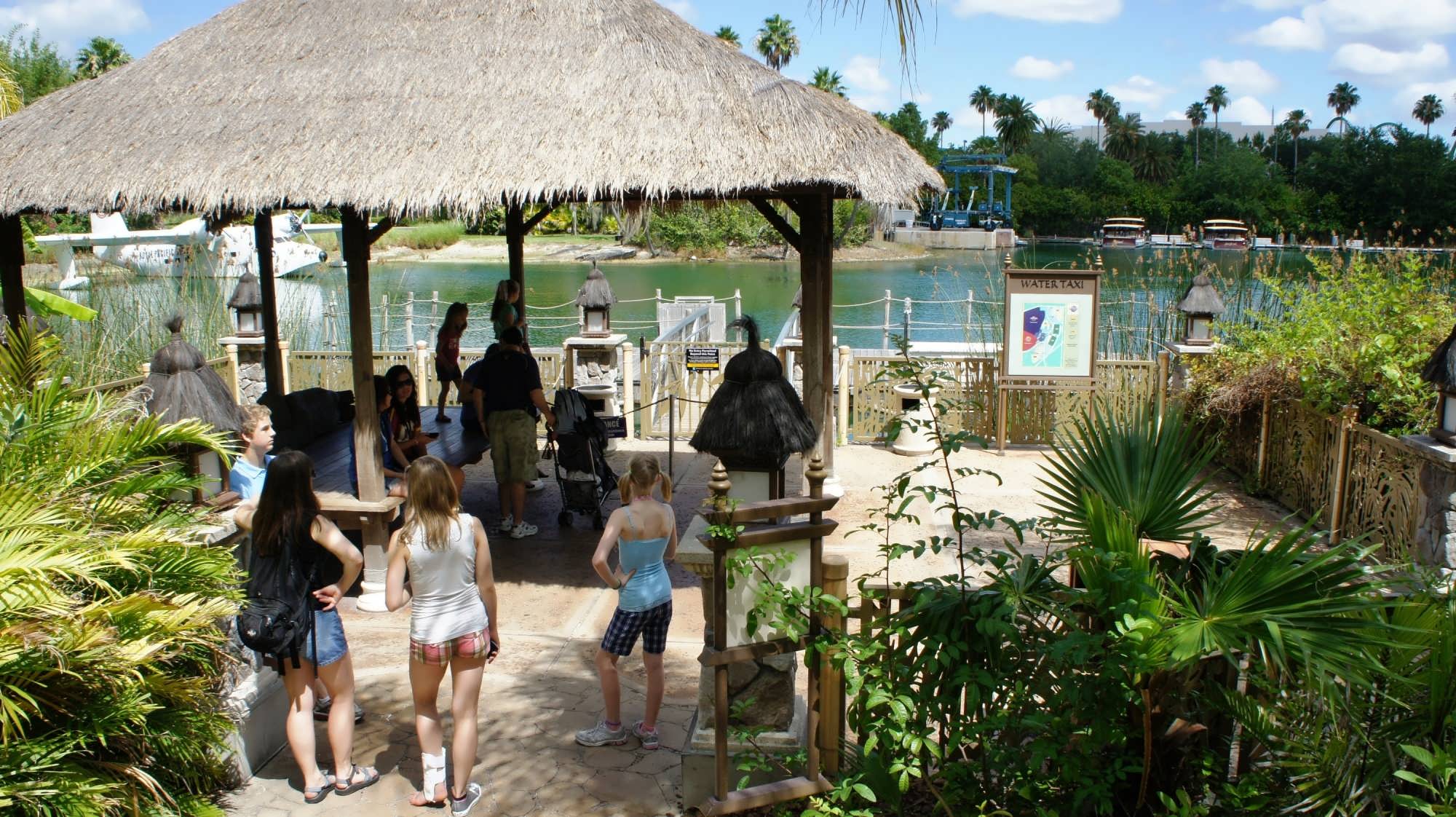 A thatched roof provides shade for guests on the water taxi dock at Royal Pacific Resort