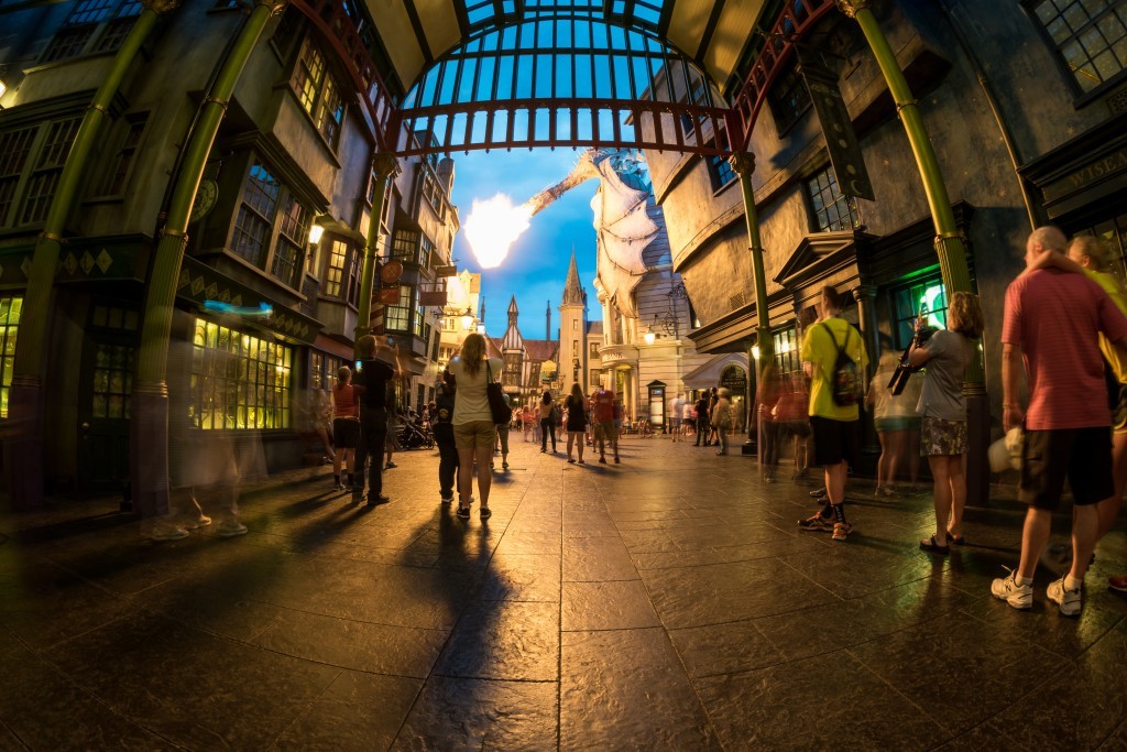 As the sun sets and night approaches, low shots inside of the alley with people around becomes no problem. It not only adds a sense of reality to the photo, but it also shows that even with lower crowd numbers, this dragon draws quiet the glance with her fire.