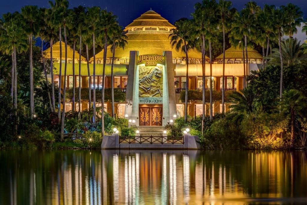 Jurassic Park Discovery Center reflects on the lagoon at night