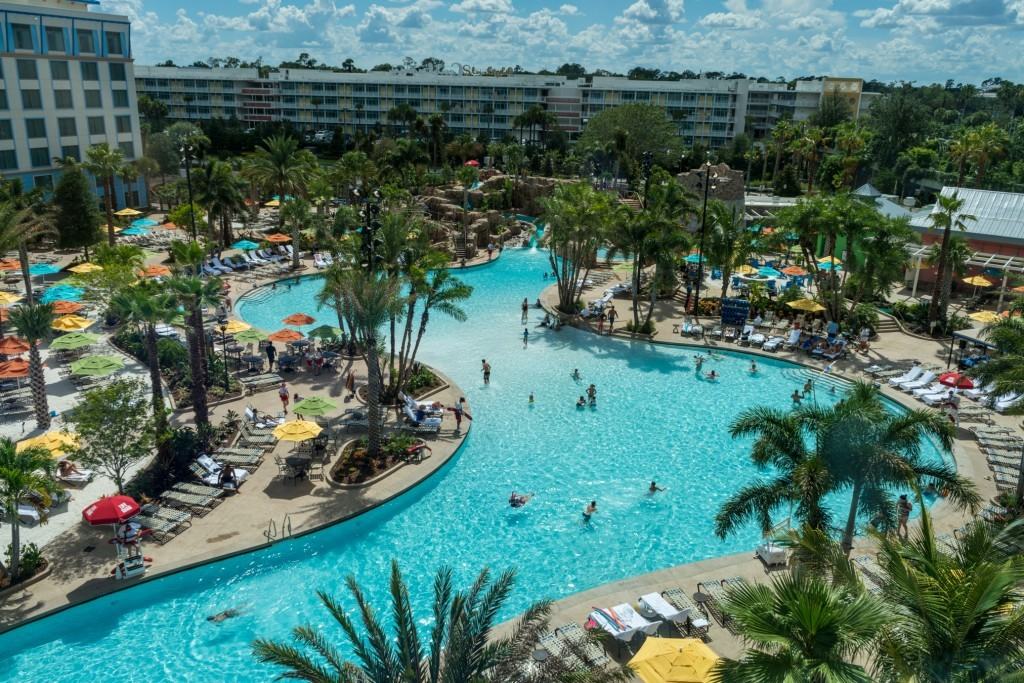 Loews Sapphire Falls Resort Pool Area at Universal Orlando, surrounded by lounge chairs and palm trees