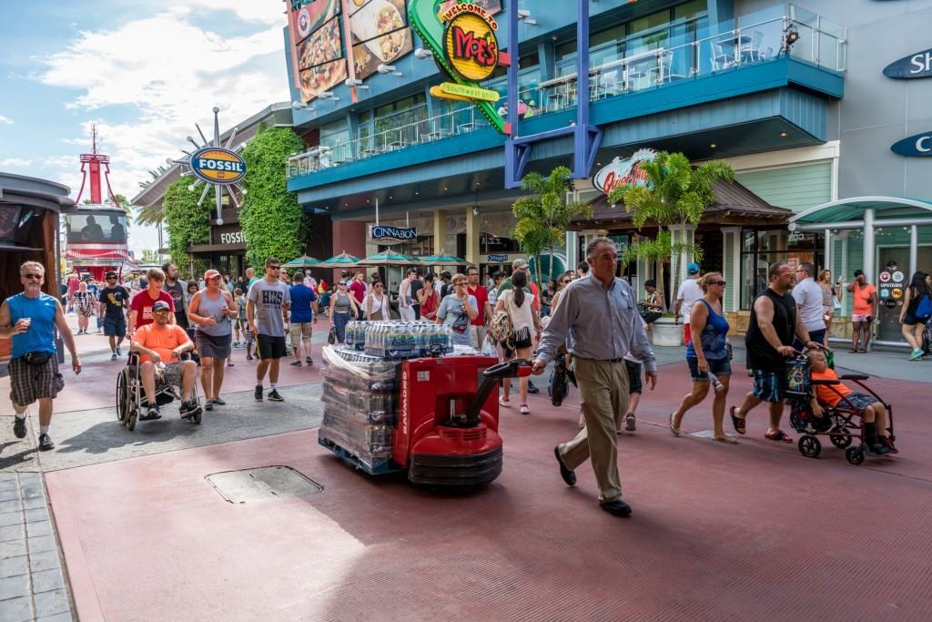 Universal Orlando Team Members distribute bottled water while transportation hub is closed