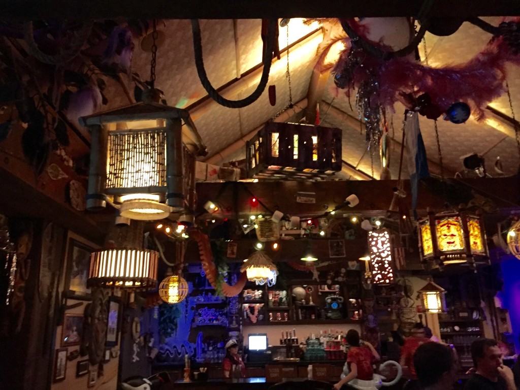 Inside Trader Sam's Grog Grotto adorned with Tiki Hut decorations including an octopus arm hanging from the ceiling.