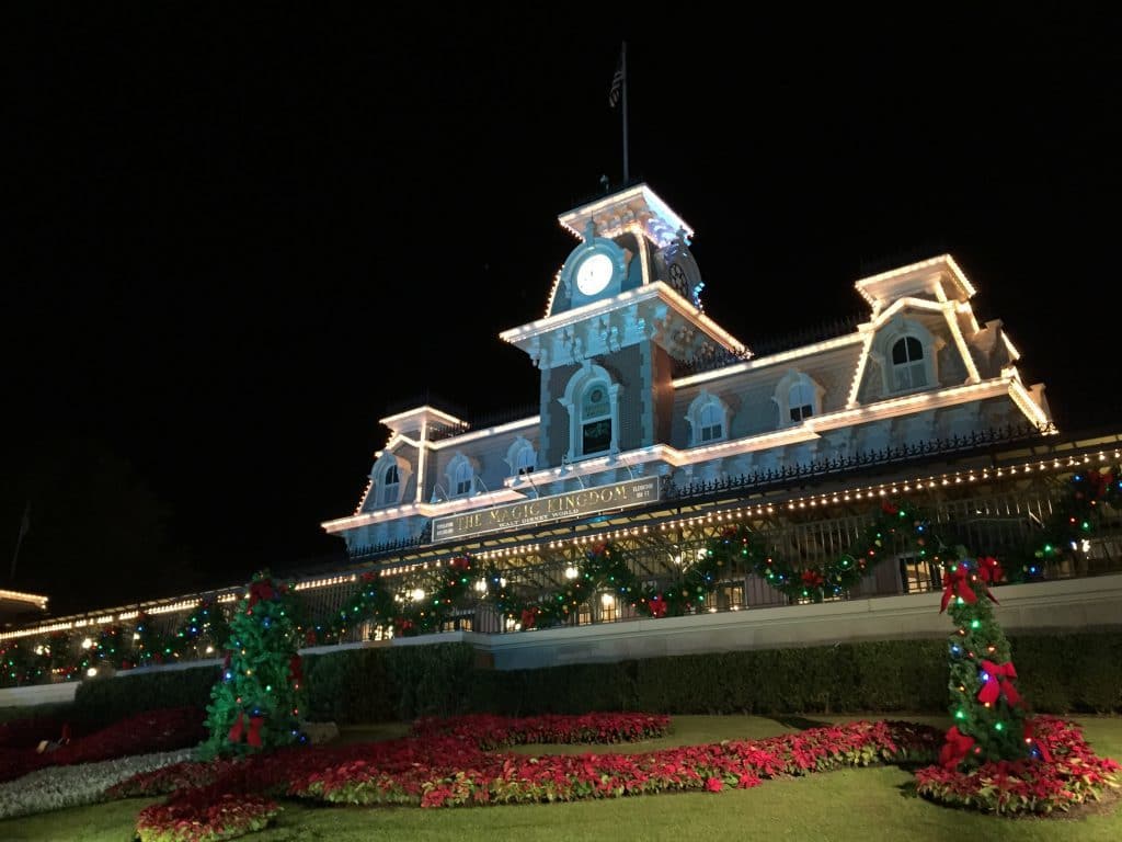 Front of Magic Kingdom train station. With red poinsettias, garland, and lights.
