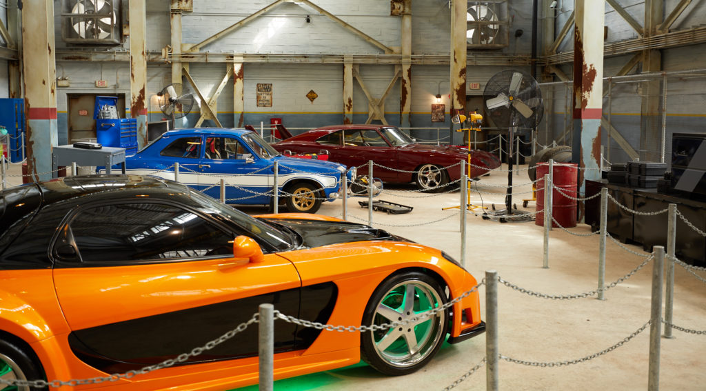 Some of the cars on display in the Fast & Furious – Supercharged queue