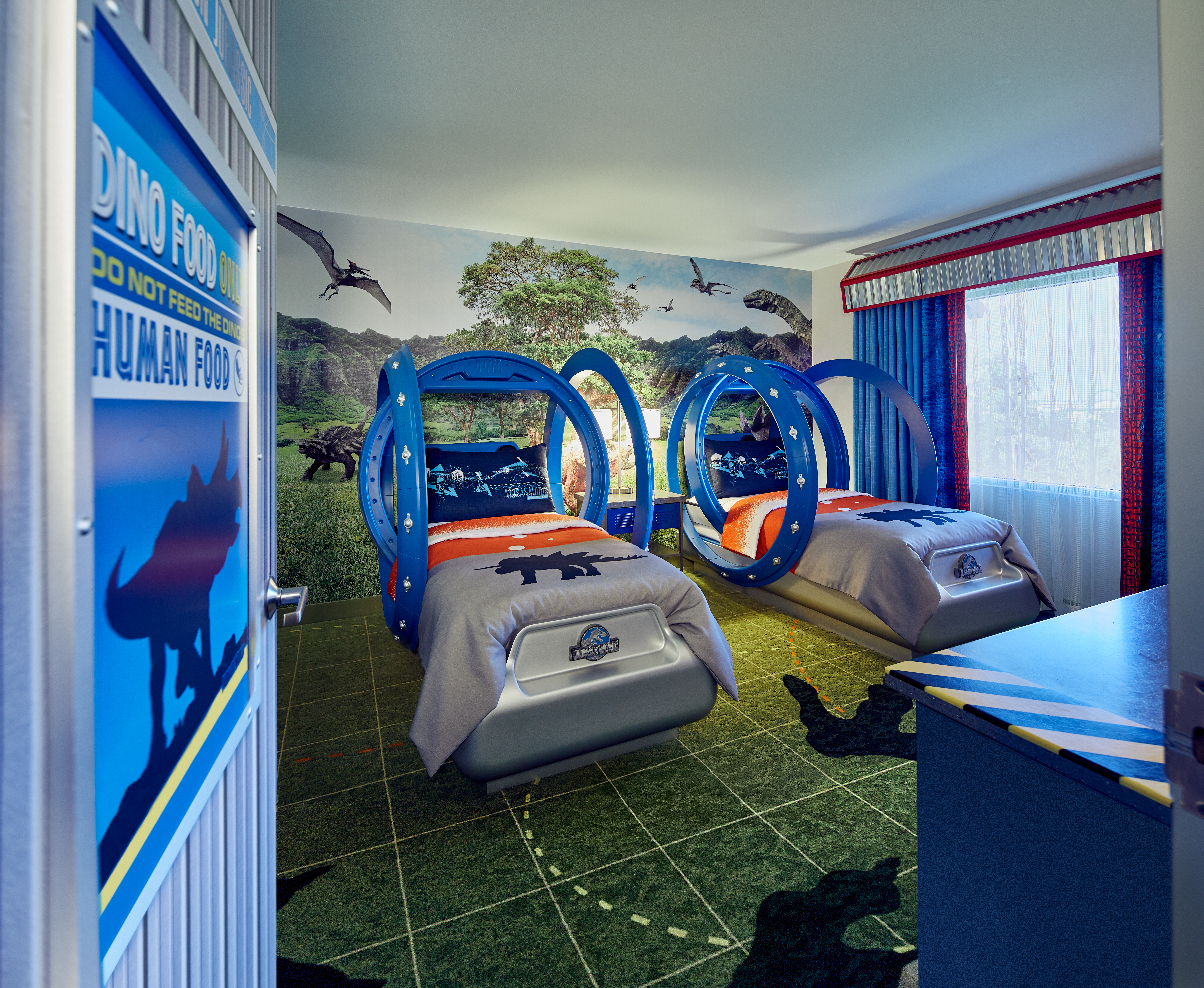 The kids room themed to Jurassic World with gyrosphere beds