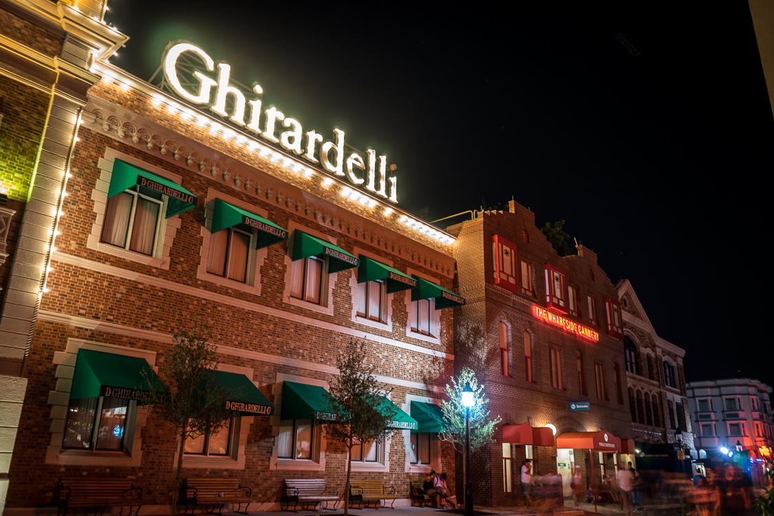 Brick facade of the replica of Ghirardelli Square, with the sign in lights