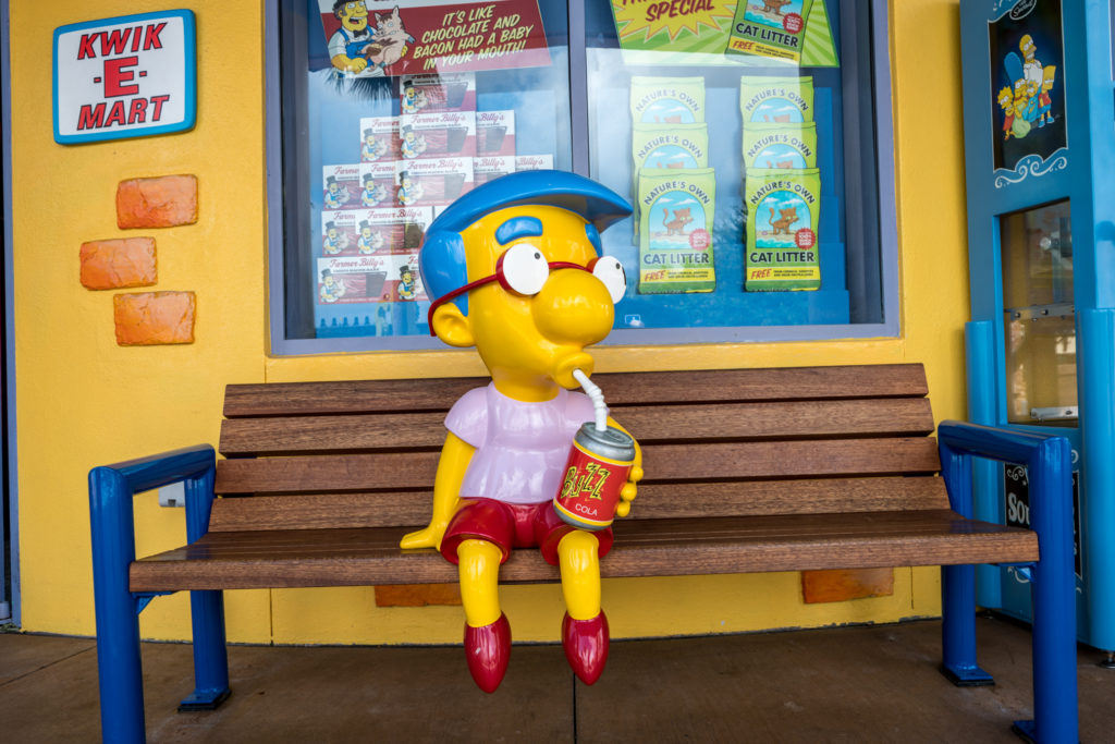 Milhouse outside of the Kiwk-E-Mart