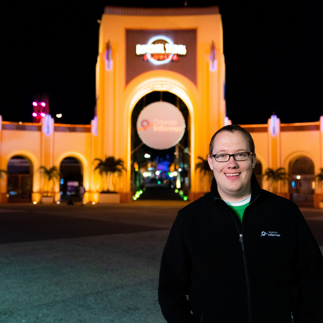 Headshot of Matthew in front of Universal Studios Florida arches with Orlando Informer medallion