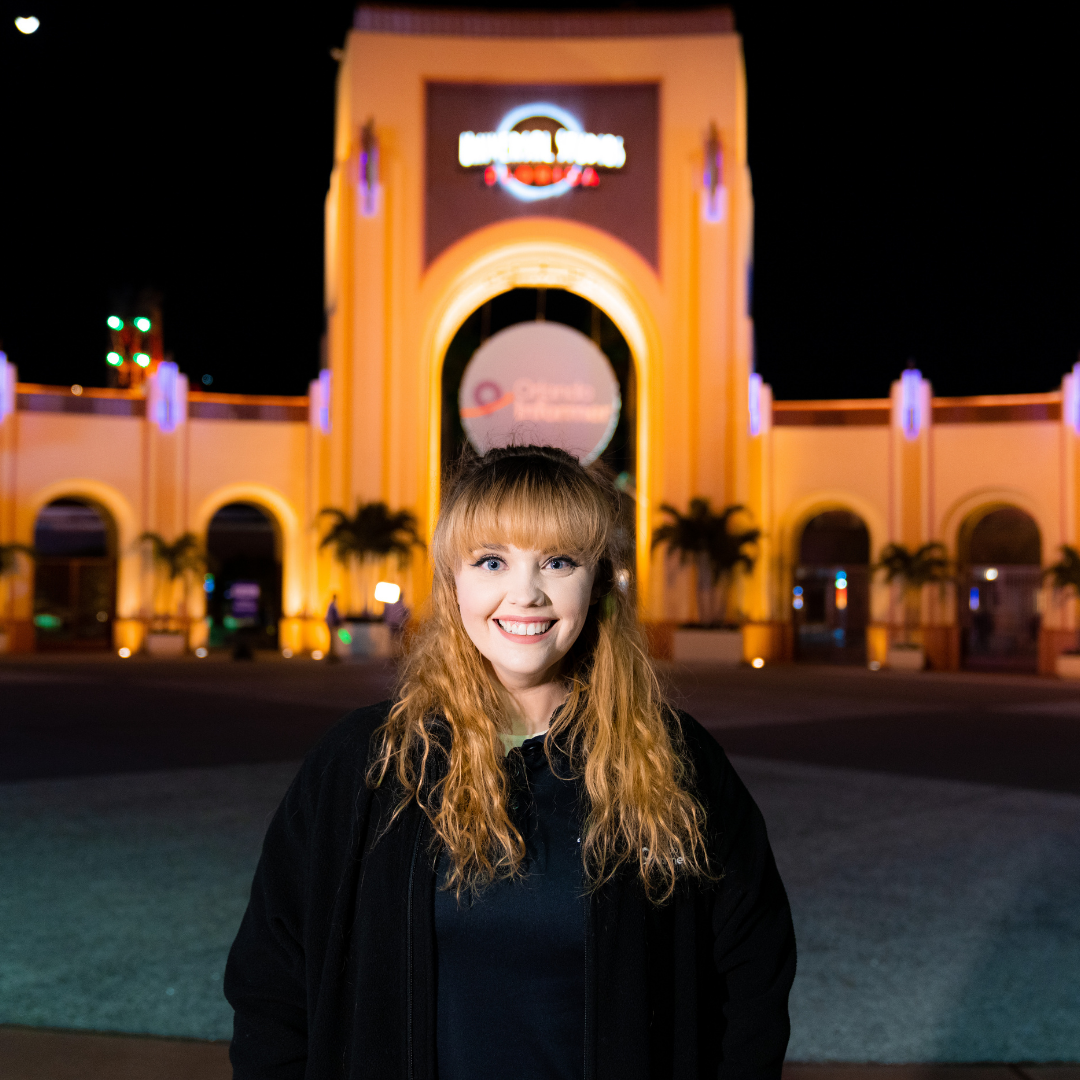 Headshot of Rebecca in front of Universal Studios Florida arches with Orlando Informer medallion