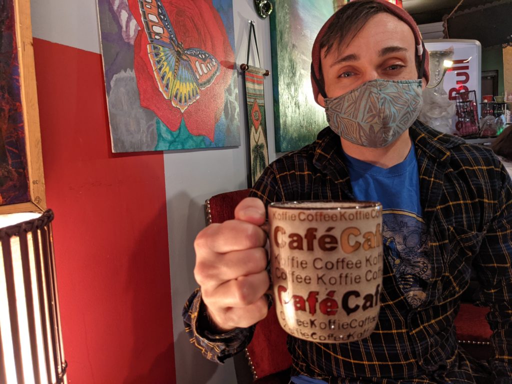 Sean looking smug with a mug at Achilles Art Cafe