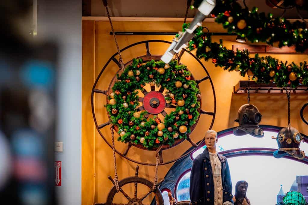 Wreath hanging on a decorative wheel inside Islands of Adventure Trading Company