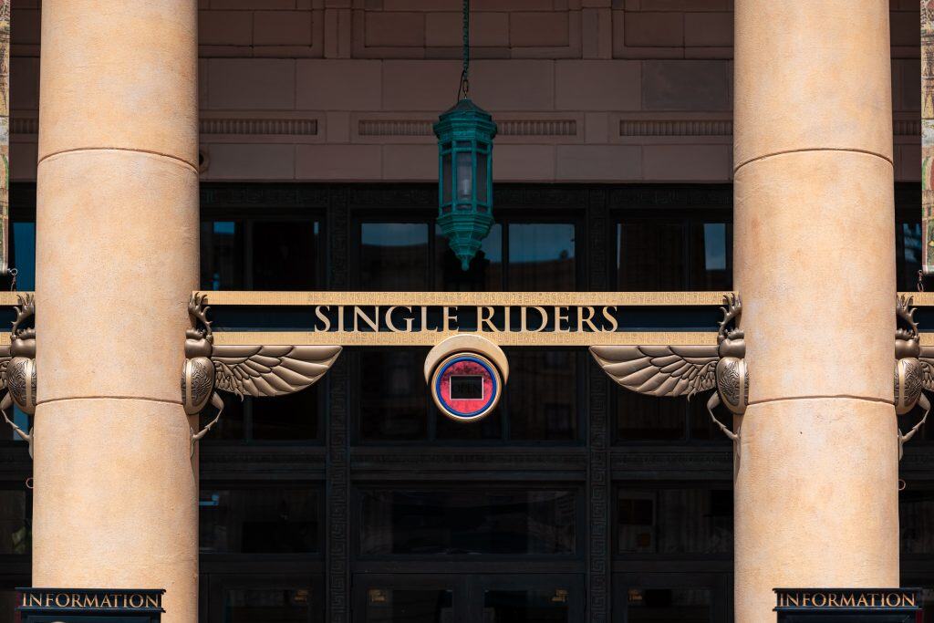 Signs indicate the entrance for the single-riders' line at Revenge of the Mummy