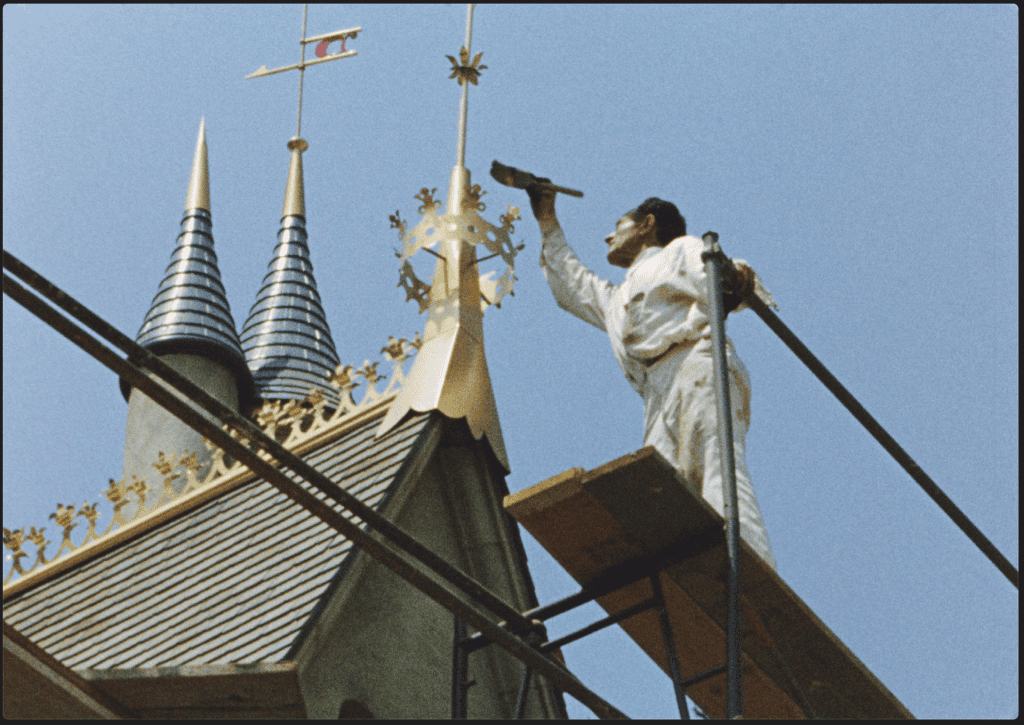 Disney employee painting the Sleeping Beauty Castle