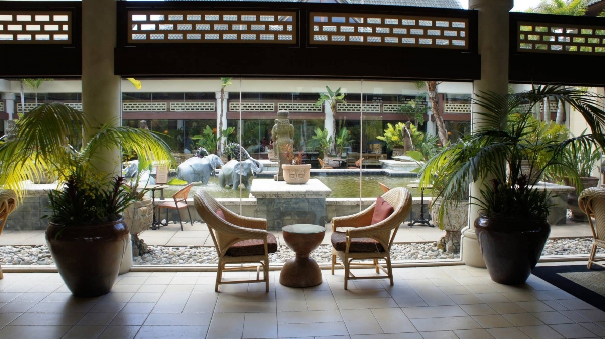 Two chairs look out onto the atrium reflecting pool, with elephant statues in the background